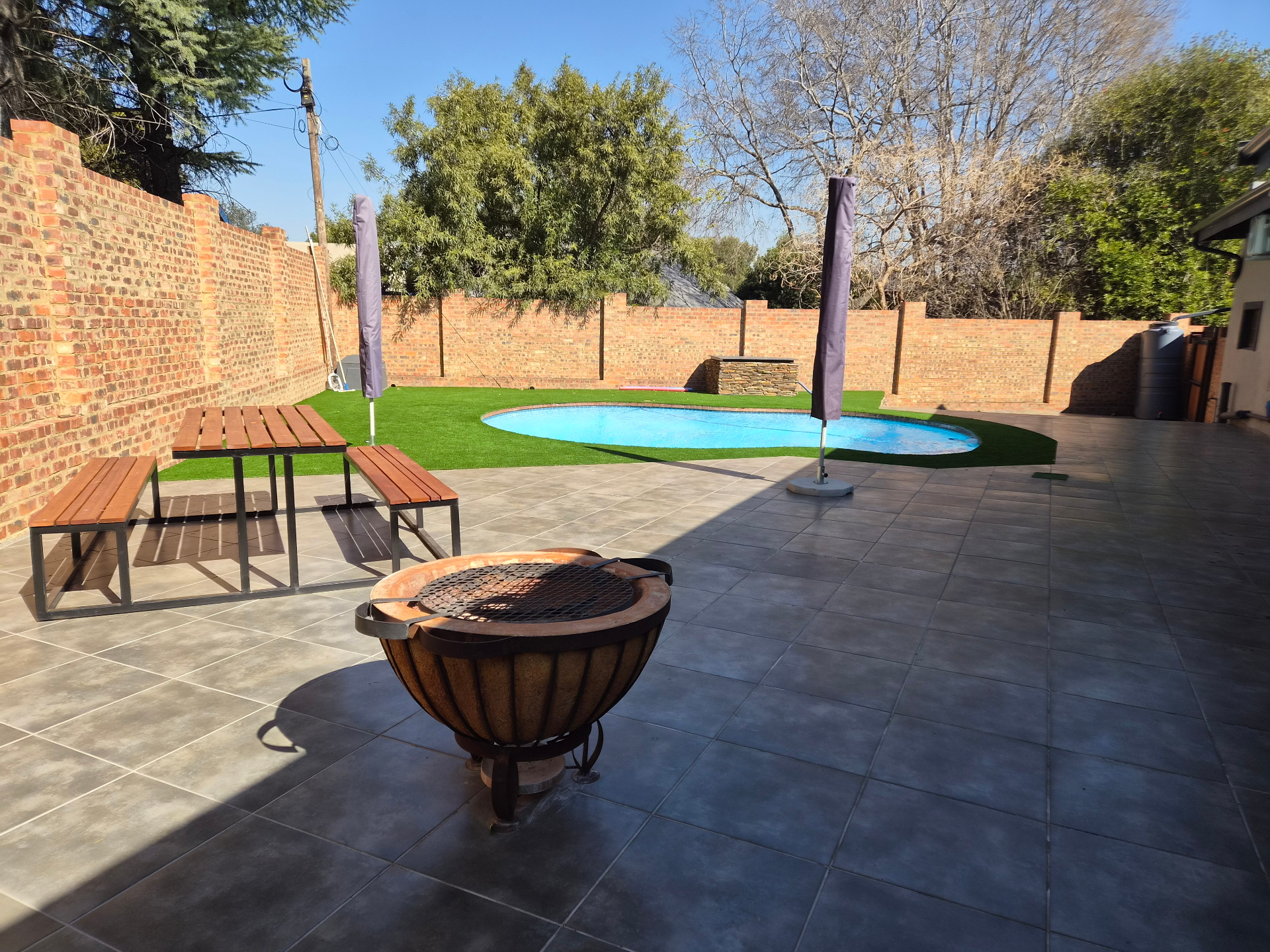 Pool area with fire pit and outdoor seating