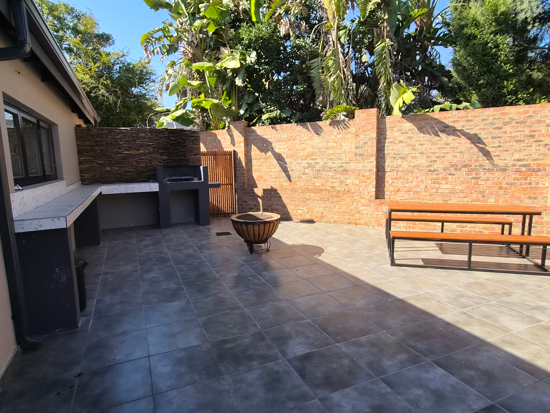 Outdoor braai area with fire pit and bench seating